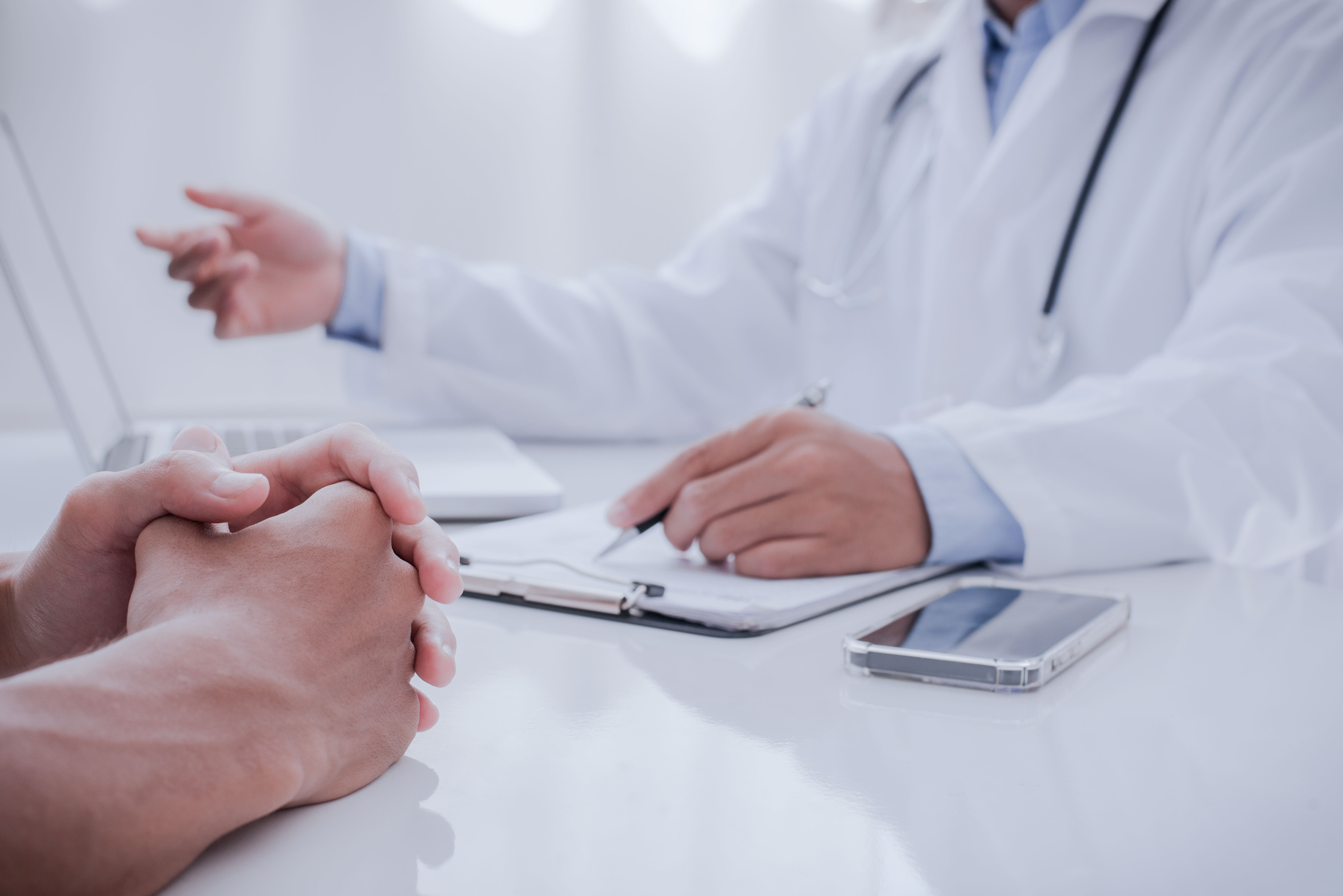 Close up of Patient and Doctor Taking Notes. Healtcare and Assis